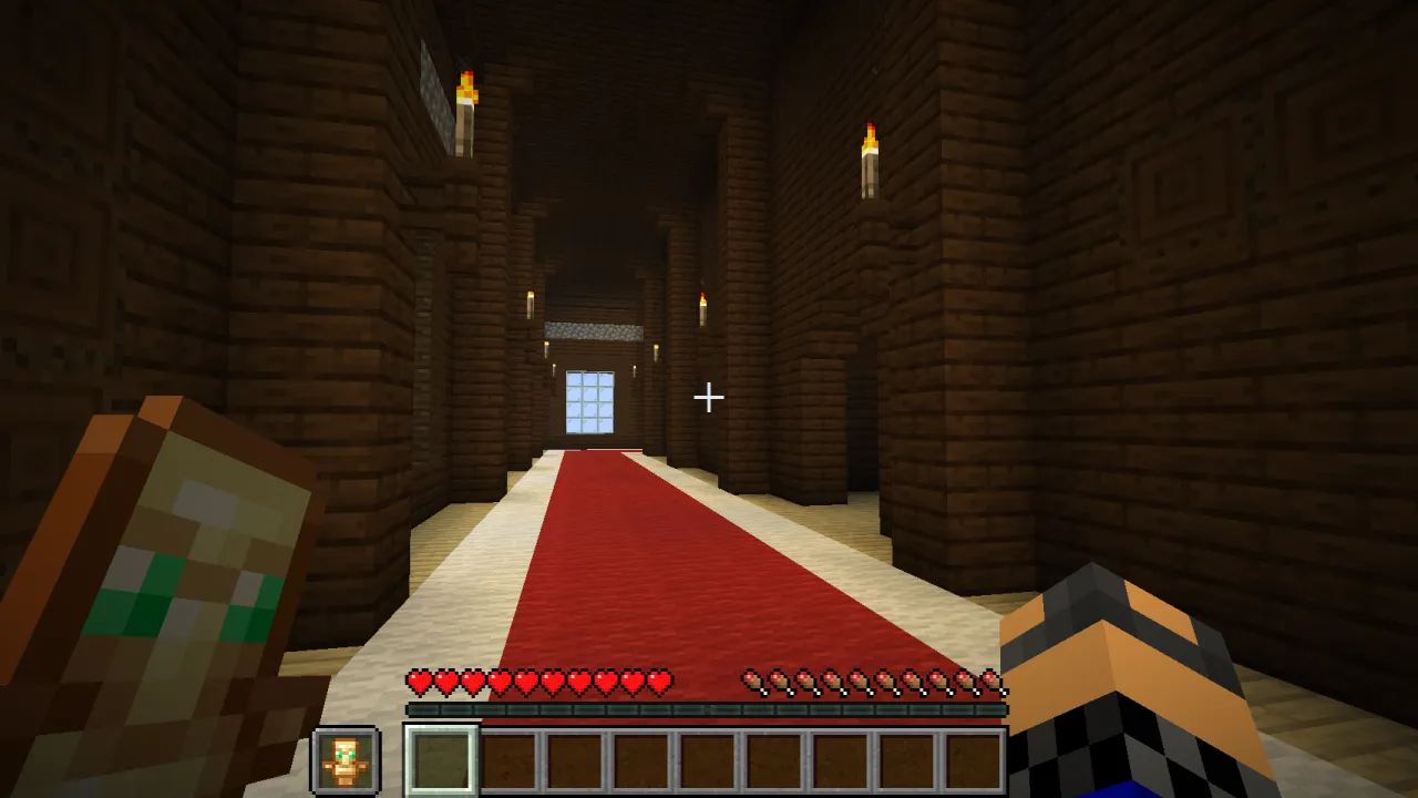 Player holding a glowing Totem of Undying in their off-hand while facing an Evoker